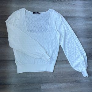 White sweater with chevron pattern